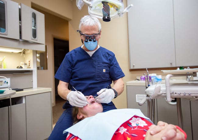 Extractions 2 Dr. Ukena works on a patient's mouth as part of a tooth extraction dental visit.
