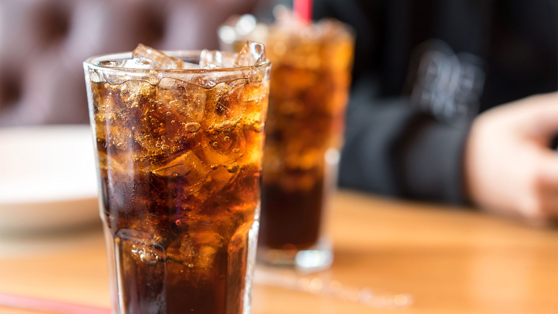 A full glass of cola reveals bubbly carbonation that's mixed with sugary, syrupy sweetness, which is bad for your teeth.