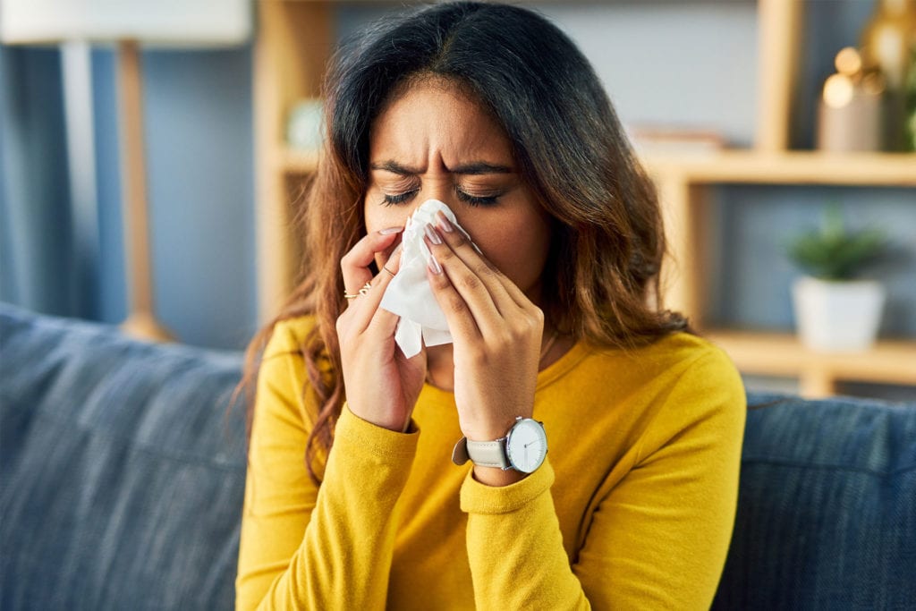 Sensitive Teeth? Spring Allergies May Be the Culprit 1 A woman with seasonal allergies blows her nose with a tissue.